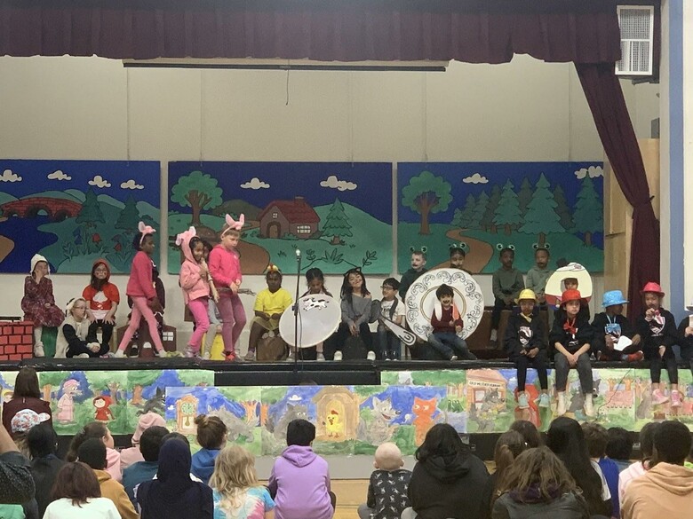 Children perform musical Mr. Wolf's Pancakes on stage in costume